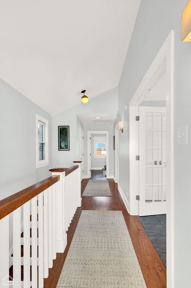 hall featuring vaulted ceiling and dark wood-type flooring