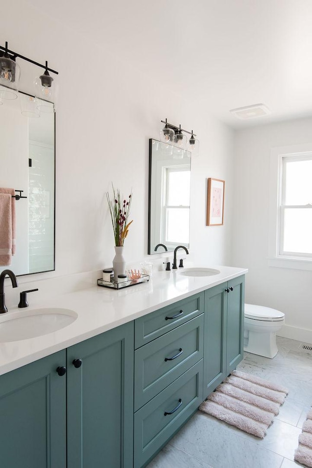 bathroom featuring vanity and toilet