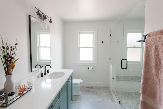 bathroom with an enclosed shower, vanity, and toilet