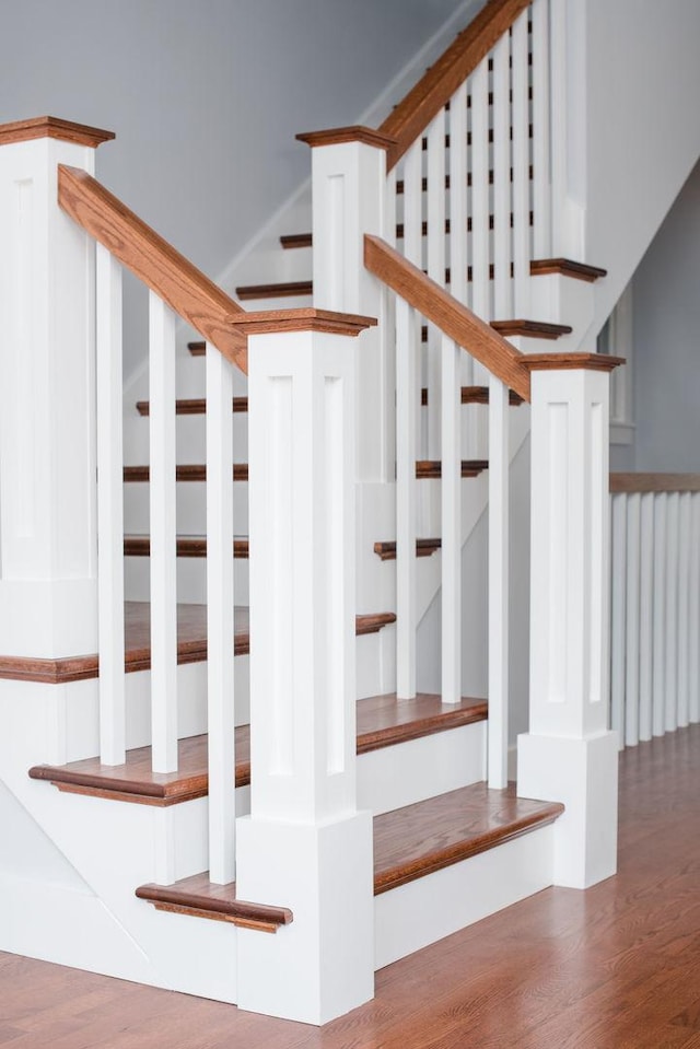 stairs with hardwood / wood-style flooring