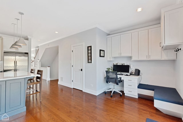 home office with ornamental molding and dark hardwood / wood-style floors