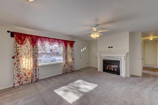 unfurnished living room with a tiled fireplace, light carpet, and ceiling fan