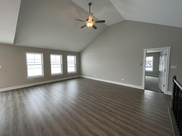 unfurnished living room featuring ceiling fan, dark hardwood / wood-style flooring, and vaulted ceiling