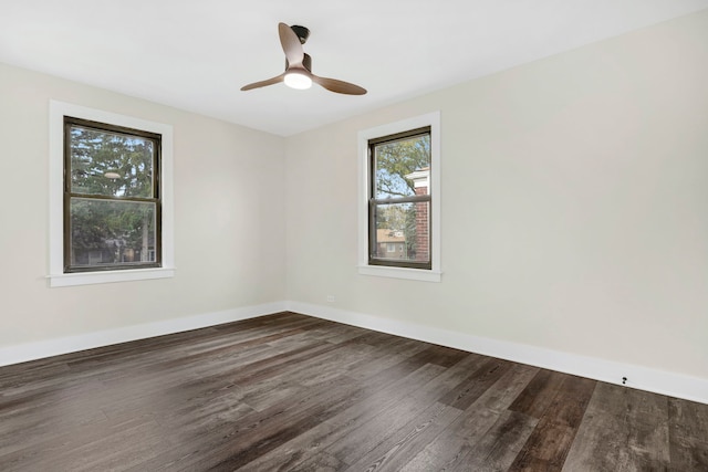 spare room featuring ceiling fan and dark hardwood / wood-style floors