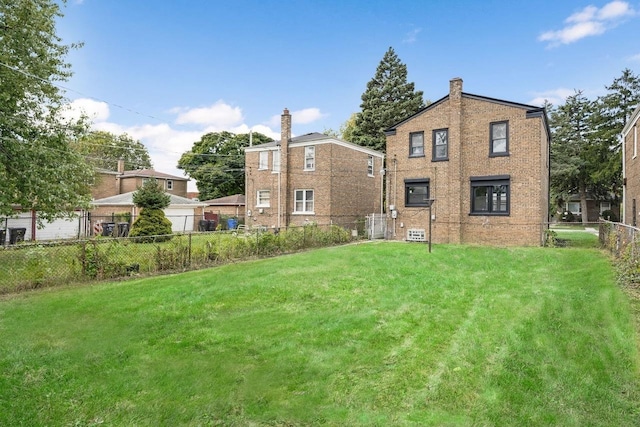 rear view of house with a lawn