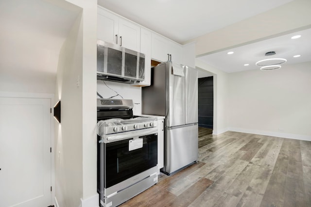 kitchen with white cabinetry, stainless steel appliances, and light hardwood / wood-style floors