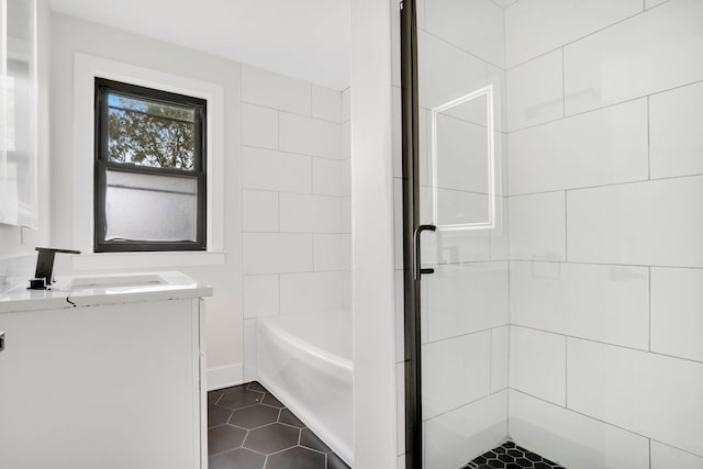 bathroom with vanity and separate shower and tub