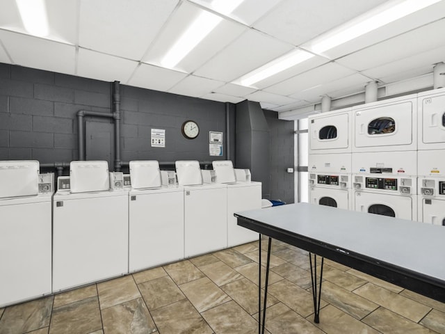 laundry area with stacked washer and clothes dryer and washing machine and clothes dryer