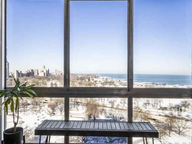 unfurnished sunroom featuring a water view