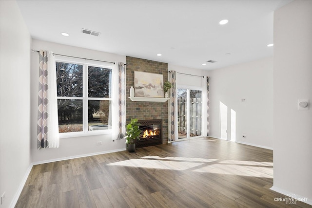 unfurnished living room with a fireplace and hardwood / wood-style floors