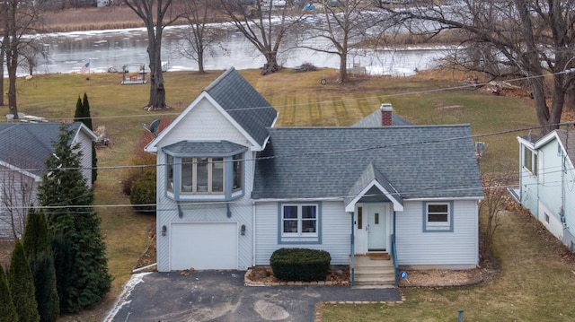 view of front of home with a water view and a garage