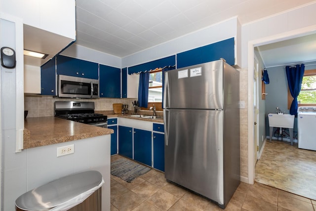 kitchen featuring sink, stainless steel appliances, stone countertops, and blue cabinets