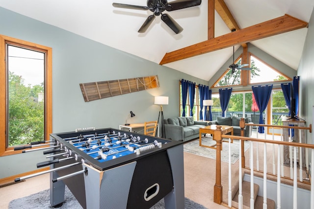 rec room with vaulted ceiling with beams, ceiling fan, a healthy amount of sunlight, and carpet