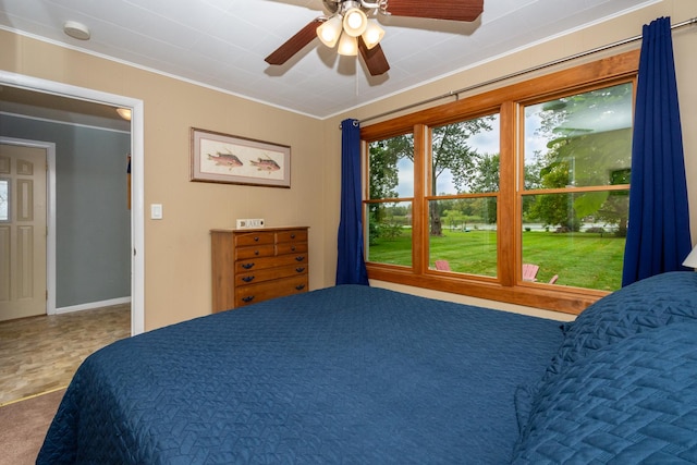 bedroom with ceiling fan and ornamental molding