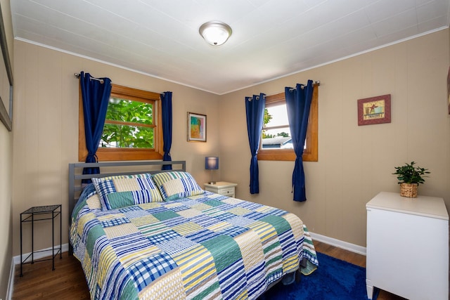 bedroom featuring dark hardwood / wood-style floors and crown molding