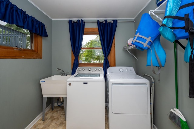 washroom with washer and clothes dryer and sink