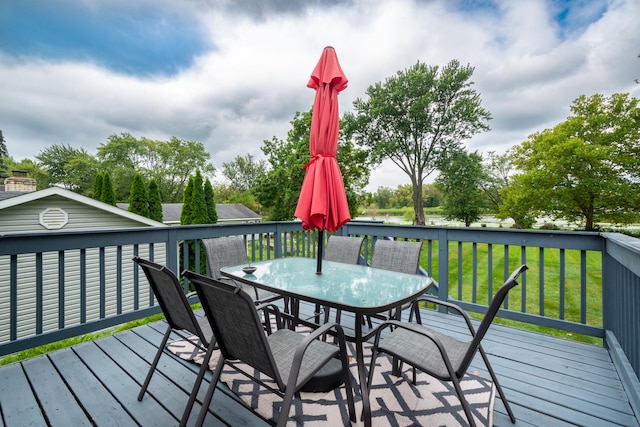 wooden deck with a lawn