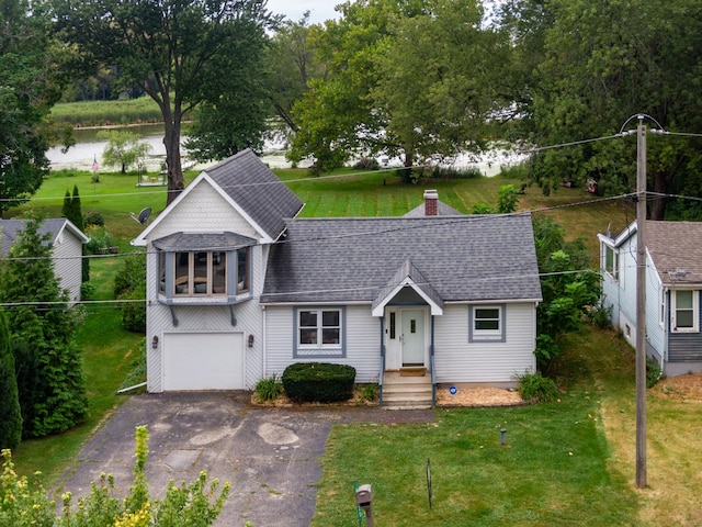 view of front facade featuring a water view and a garage