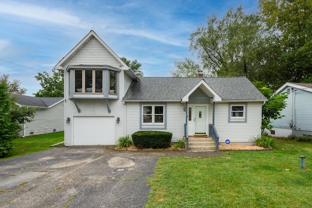 view of front of property with a garage and a front lawn