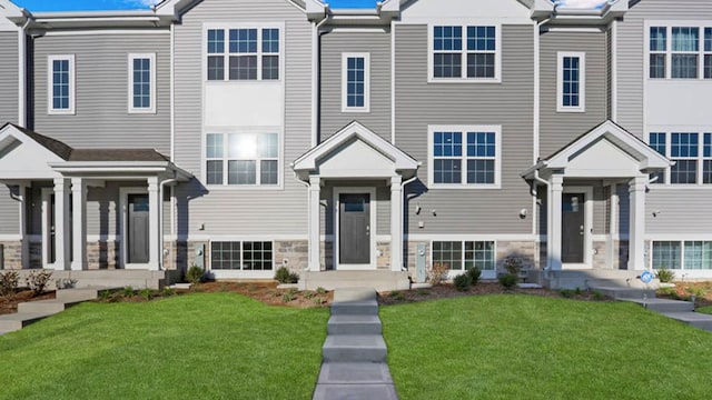 view of property featuring a front yard