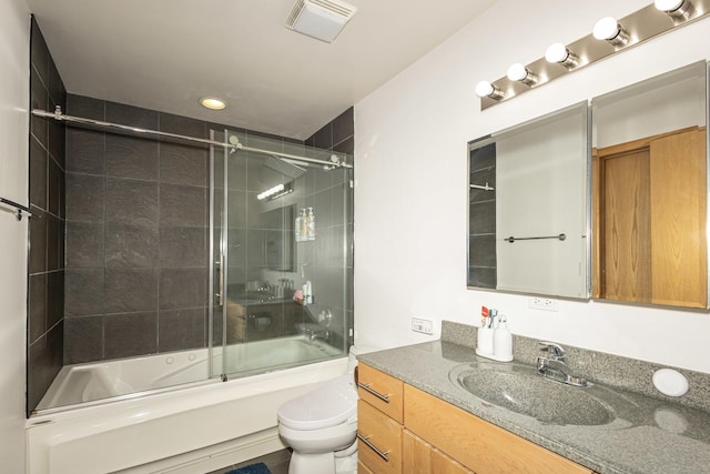 full bathroom with bath / shower combo with glass door, toilet, and vanity