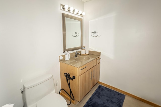 bathroom featuring toilet, vanity, and tile patterned floors