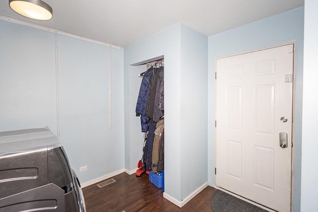 laundry area with separate washer and dryer and dark hardwood / wood-style floors