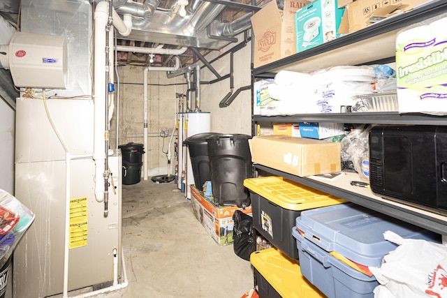 storage area featuring heating unit and gas water heater