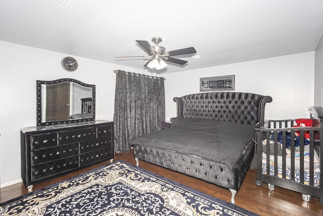 bedroom featuring ceiling fan and dark hardwood / wood-style flooring