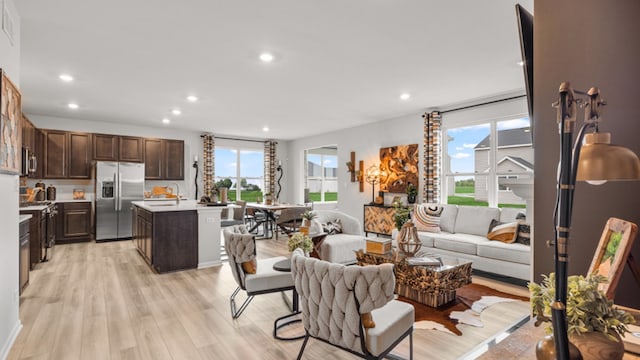 living room featuring light hardwood / wood-style floors and sink