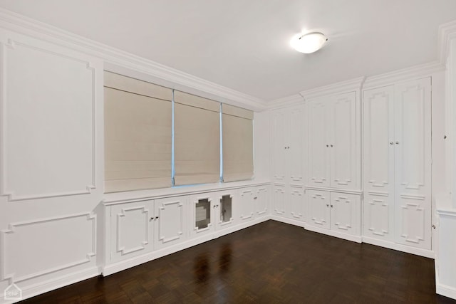 interior space with dark parquet floors and ornamental molding