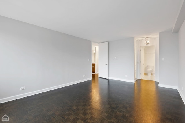 unfurnished room featuring dark parquet floors