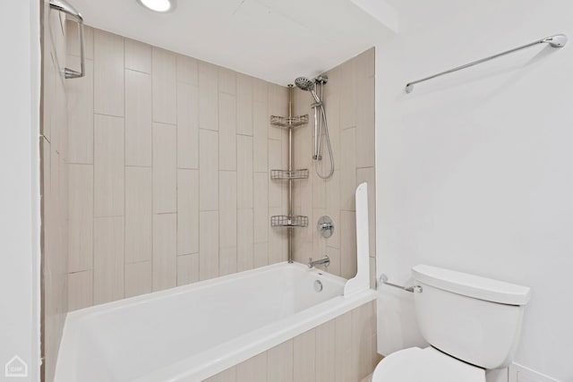 bathroom featuring tiled shower / bath combo and toilet