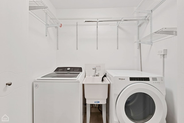 washroom featuring washer and clothes dryer and sink