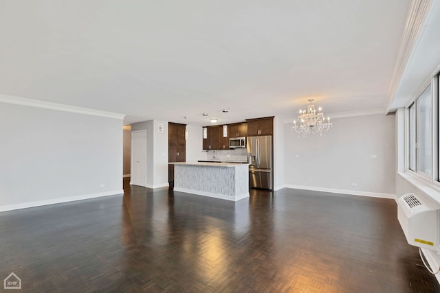 unfurnished living room with a notable chandelier, ornamental molding, a wall mounted AC, and dark parquet floors