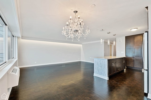 kitchen with dark parquet flooring, dark brown cabinets, a chandelier, stainless steel refrigerator, and hanging light fixtures