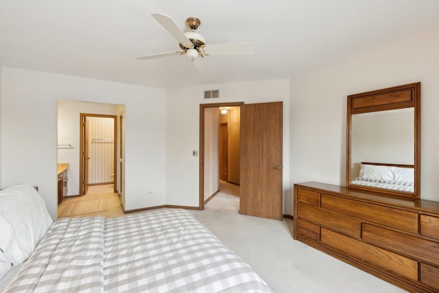 carpeted bedroom with connected bathroom and ceiling fan