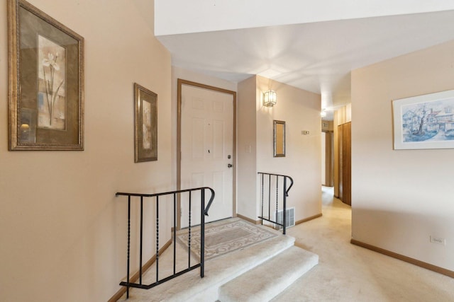 corridor with light colored carpet