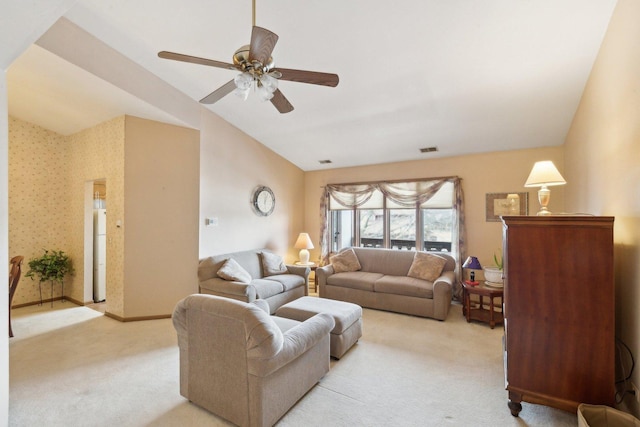 carpeted living room featuring ceiling fan and vaulted ceiling