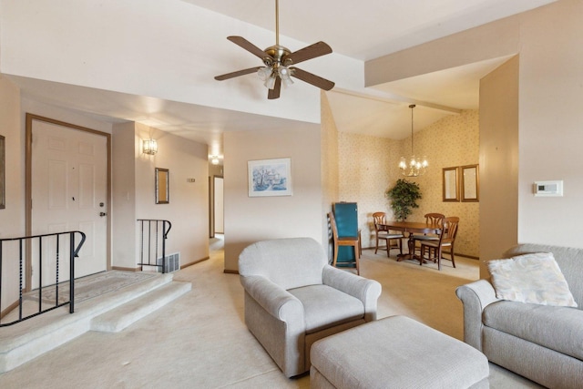 living room with ceiling fan with notable chandelier, lofted ceiling, and light carpet