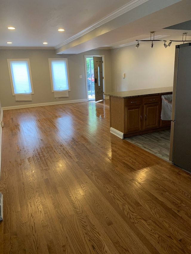 unfurnished room featuring light hardwood / wood-style floors and ornamental molding