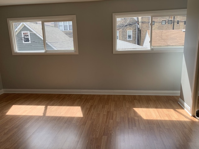 unfurnished room featuring hardwood / wood-style floors and a wealth of natural light