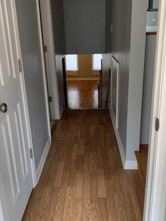 corridor with light hardwood / wood-style floors