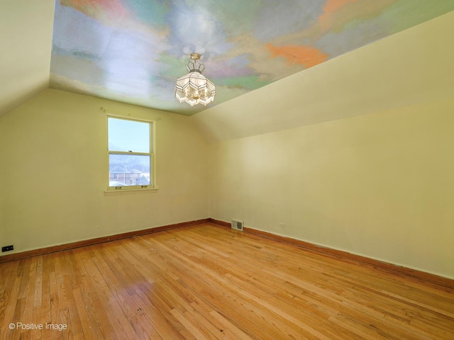 bonus room featuring light wood-type flooring and lofted ceiling