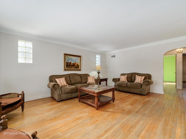 living room with ornamental molding and light hardwood / wood-style floors