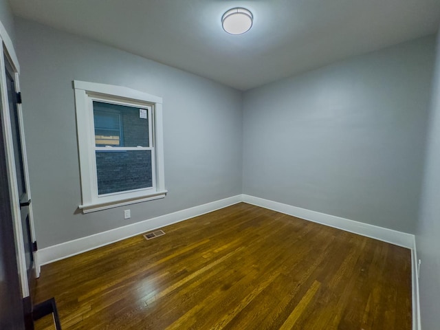 empty room featuring dark hardwood / wood-style floors