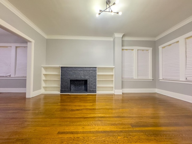 unfurnished living room with wood-type flooring, crown molding, and a notable chandelier