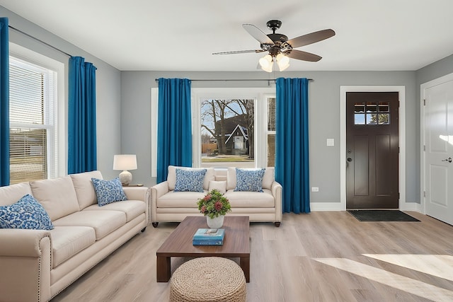 living room featuring ceiling fan and light hardwood / wood-style floors