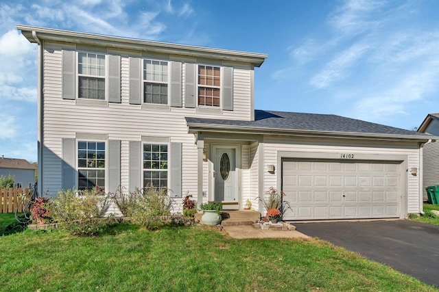 front facade featuring a garage and a front yard