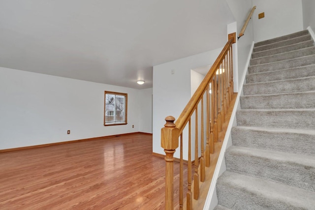 stairs with hardwood / wood-style floors